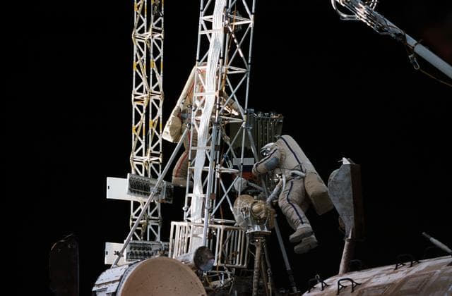 NASA image:  Mir 21 cosmonauts assemble a truss during EVA