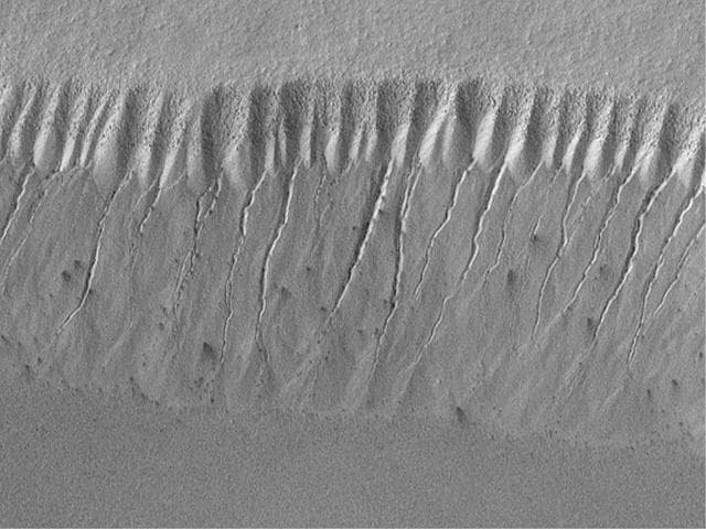 NASA image: Evidence for Recent Liquid Water on Mars: Gullies at 70°S in Polar Pit Walls