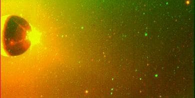 NASA image: Io Sodium Cloud On-Chip Format Clear and Green-Yellow Filters Superimposed
