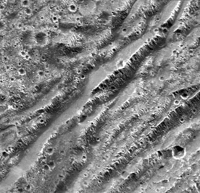 NASA image: Stair-step Scarps in Dark Terrain on Ganymede