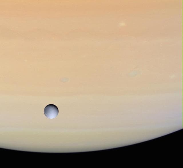 NASA image: Dione and Saturn