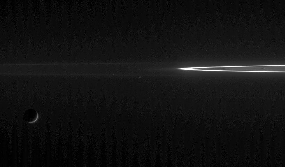 NASA image: Darkened Moons, Searing F Ring
