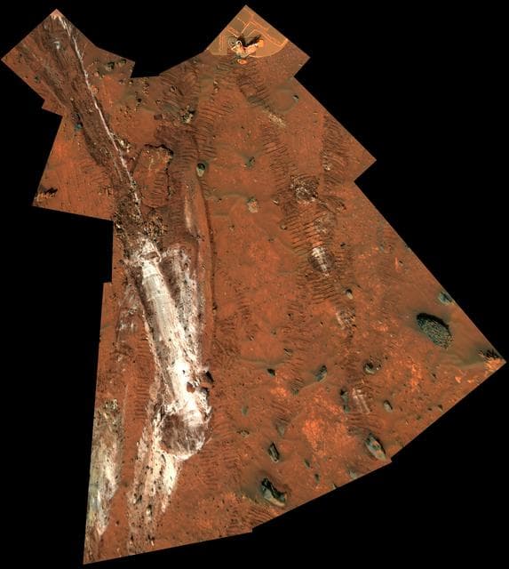 NASA image: Rover Wheel Churns Up Bright Martian Soil Vertical