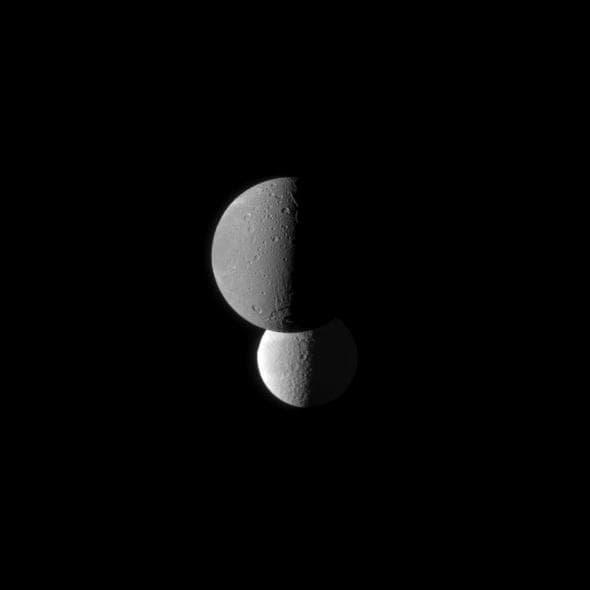 NASA image: Tethys and Darker Dione
