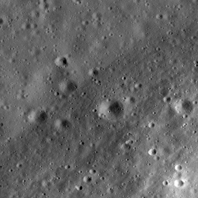 NASA image: Riccioli Crater: Cracked, Melted, and Draped
