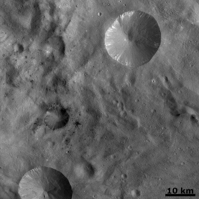 NASA image: Dark Areas in Cratered Terrain on Vesta
