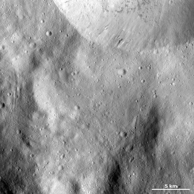 NASA image: Sharp Crater Rim with Dark Material and Boulders