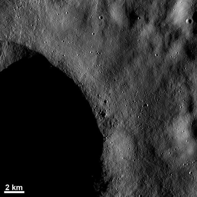 NASA image: Blocks of Ejected Material and Small Craters Near a Crater Rim