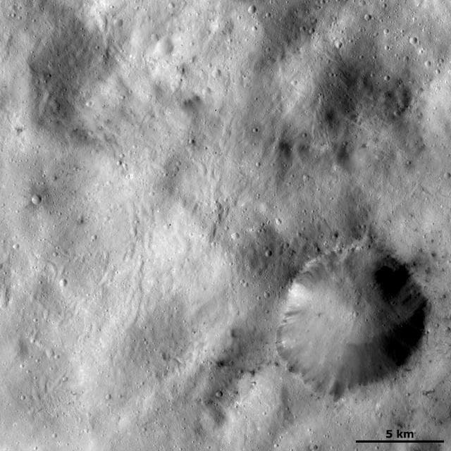 NASA image: Spots of Dark Material Surrounding an Impact Crater