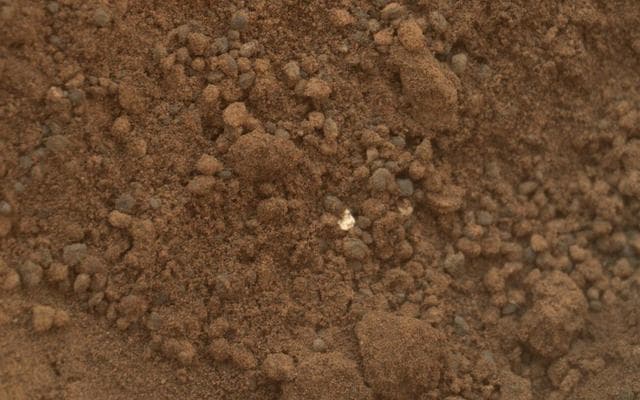 NASA image: Bright Particle in Hole Dug by Scooping of Martian Soil