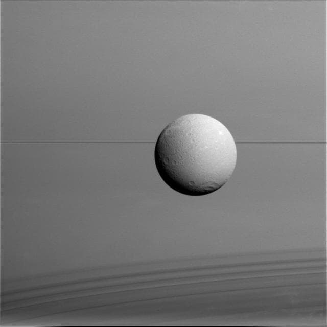 NASA image: Dione with Rings and Shadows