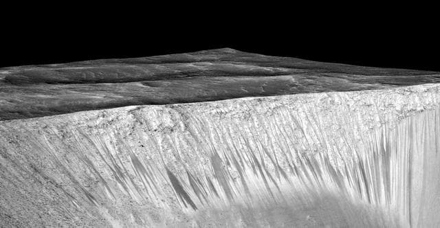 NASA image: Dark, Recurring Streaks on Walls of Garni Crater