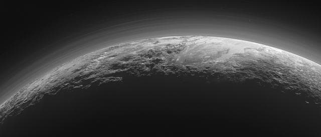 NASA image: Pluto Majestic Mountains, Frozen Plains and Foggy Hazes