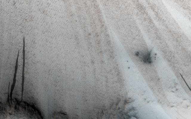NASA image: A New Crater on a Dusty Slope
