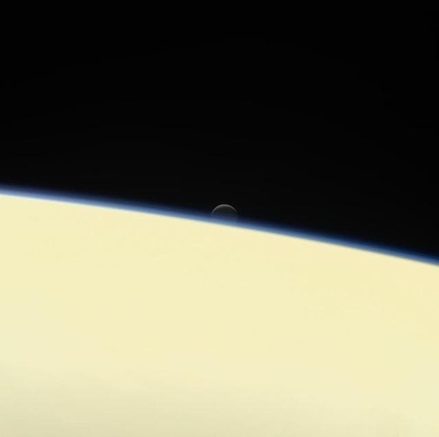 NASA image: Enceladus Stetting Behind Saturn (Image & Movie)