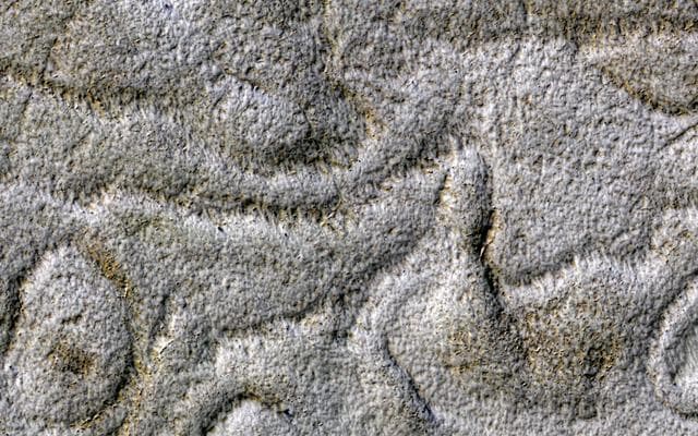 NASA image: Curving Ridges and Pits
