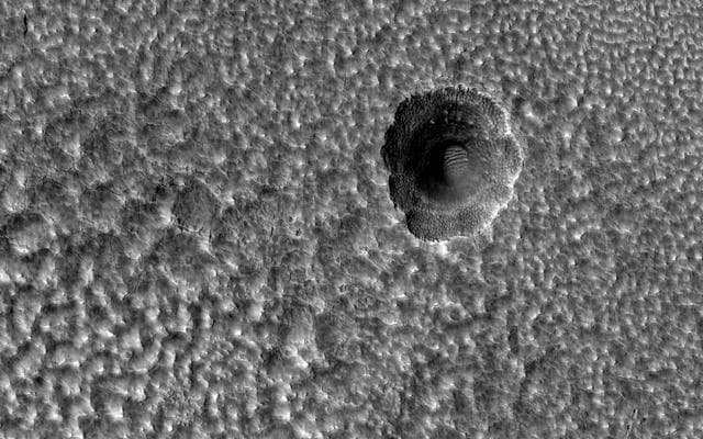 NASA image: A Crater Enlarged by the Sublimation of Ice