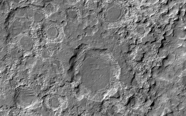 NASA image: Dark Patches Formed by Craters