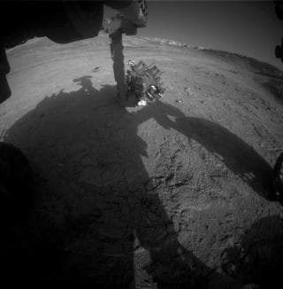 NASA image: Curiosity Works Its Robotic Arm During Sunset