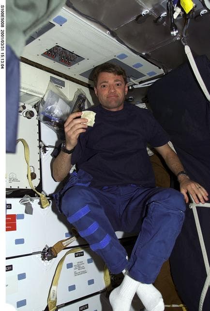 NASA image: Pilot Ashby eats a meal on the middeck of Endeavour