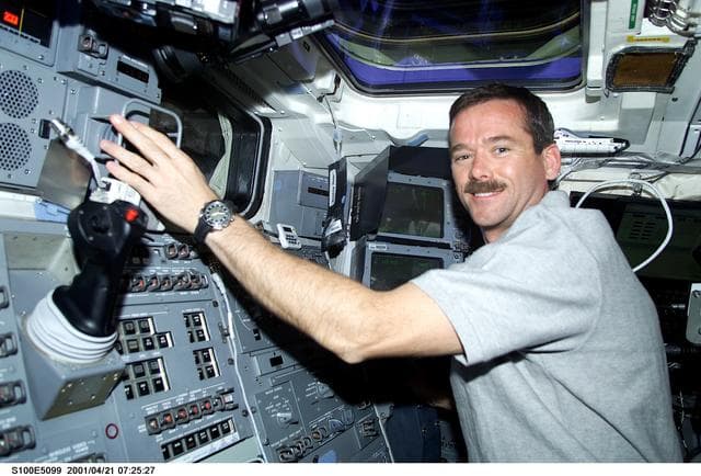 NASA image: MS Hadfield works at the RMS Translation Hand Controller on the aft flight deck of Endeavour