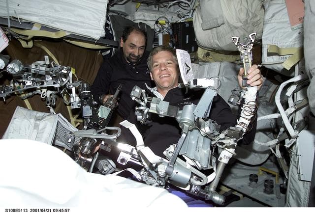 NASA image: MS Parazynski and MS Guidoni work on EVA harness on the middeck of Endeavour