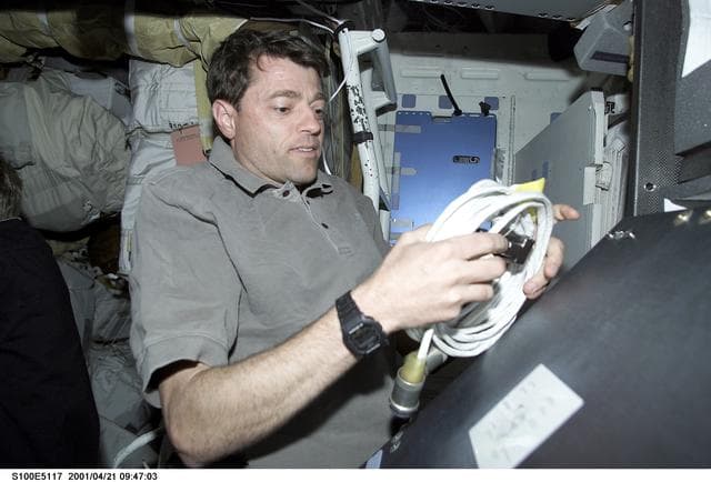 NASA image: Pilot Ashby unpacks a cable on the middeck of Endeavour