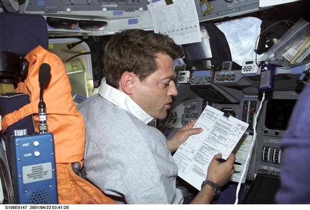 NASA image: Pilot Ashby reviews a checklist at the commander's workstation on the flight deck of Endeavour
