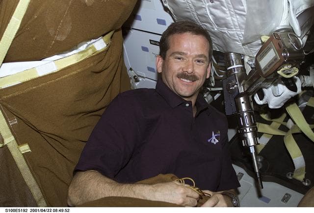 NASA image: MS Hadfield checks out a Pistol Grip Tool on the middeck of Endeavour