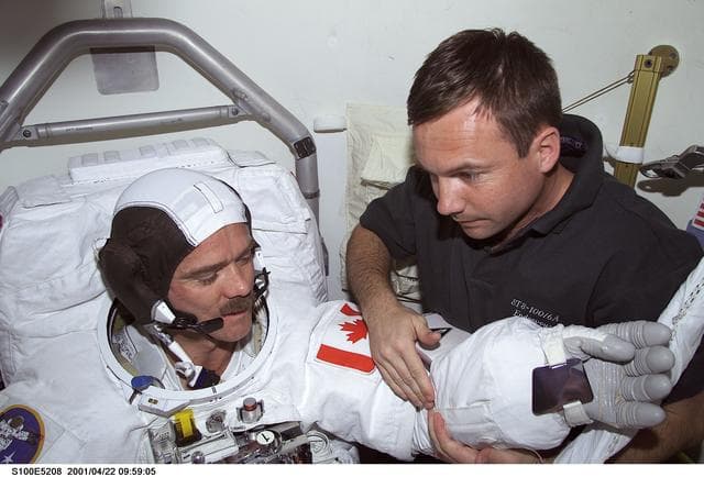 NASA image: MS Lonchakov helps MS Hadfield with his EMU before the first EVA of STS-100
