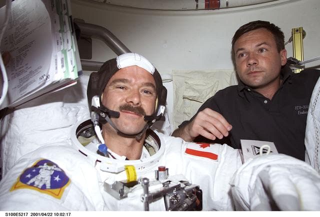 NASA image: MS Lonchakov helps MS Hadfield with his EMU before the first EVA of STS-100