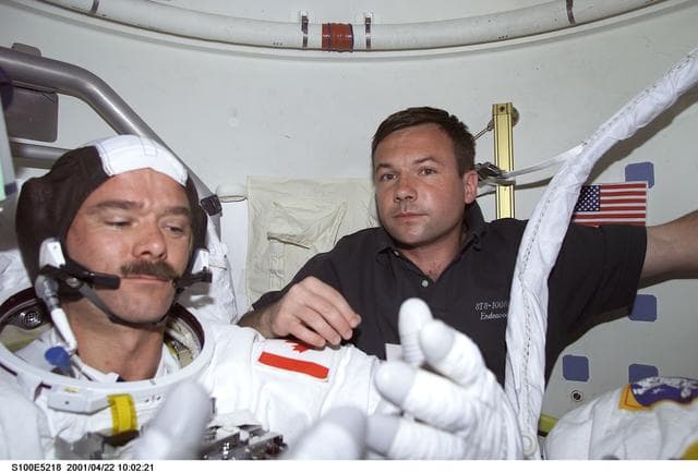 NASA image: MS Lonchakov helps MS Hadfield with his EMU before the first EVA of STS-100