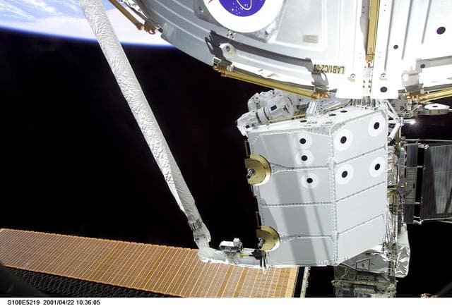 NASA image: View of the RMS grappling the Spacelab Pallet during STS-100
