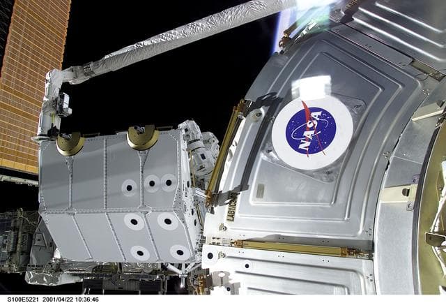 NASA image: View of the RMS grappling the Spacelab Pallet during STS-100