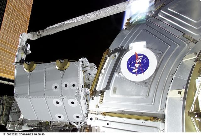 NASA image: View of the RMS grappling the Spacelab Pallet during STS-100