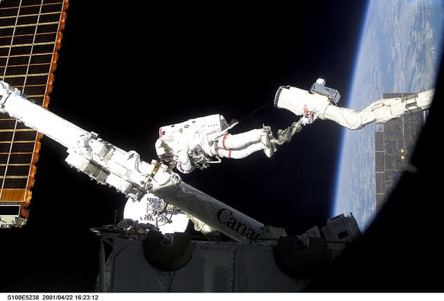 NASA image: MS Hadfield works on the SSRMS in the SLP during the first EVA for STS-100