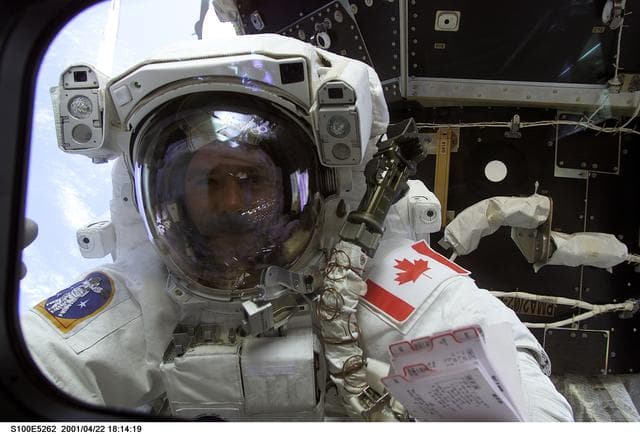 NASA image: MS Hadfield waves through a flight deck window during the first EVA of STS-100