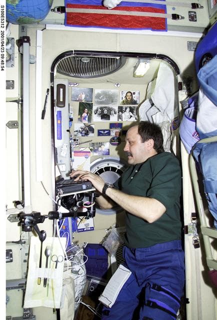 NASA image: Usachev works at his laptop computer in Zvezda during STS-100's ingress