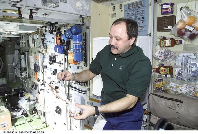 NASA image: Usachev explains the Russian segments of the ISS in Zvezda during STS-100's ingress