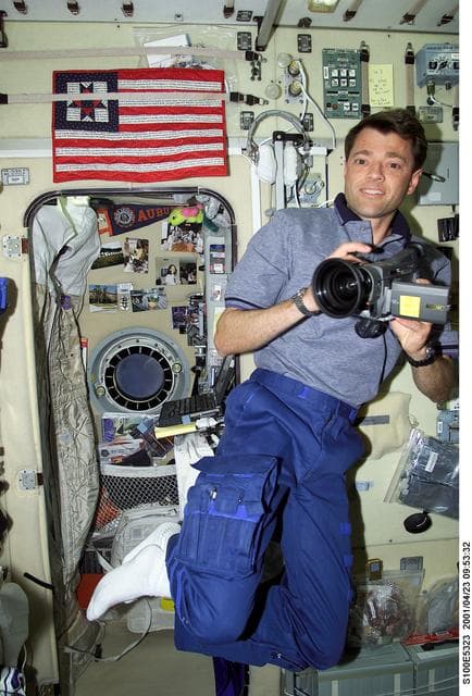 NASA image: Pilot Ashby uses a video camera in Zvezda during STS-100's ingress into the ISS