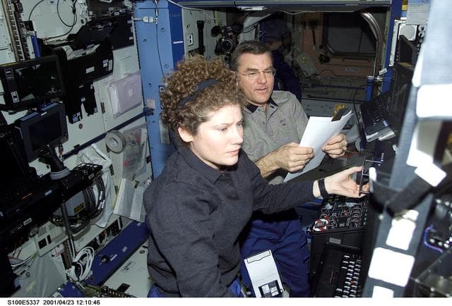 NASA image: Helms and Voss work at the SSRMS control station in the U.S. Laboratory during STS-100