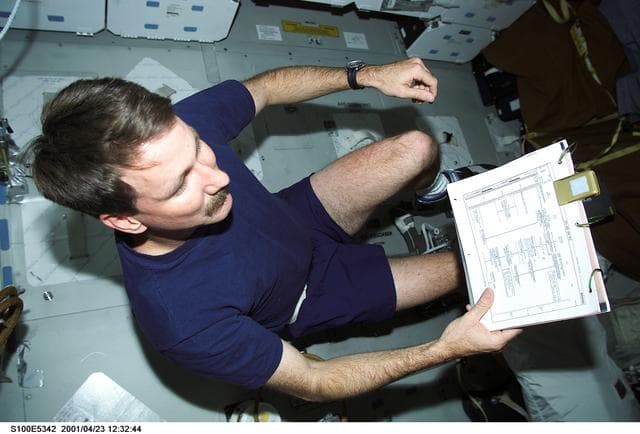 NASA image: Commander Rominger on a cycle ergometer on the middeck of Endeavour during STS-100