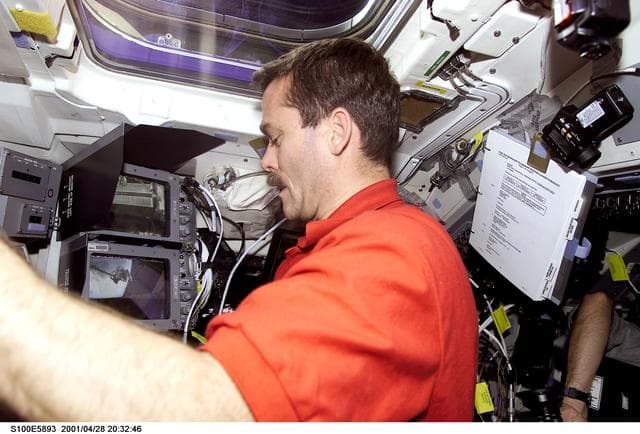 NASA image: MS Hadfield works at the RMS controls on the flight deck of Endeavour