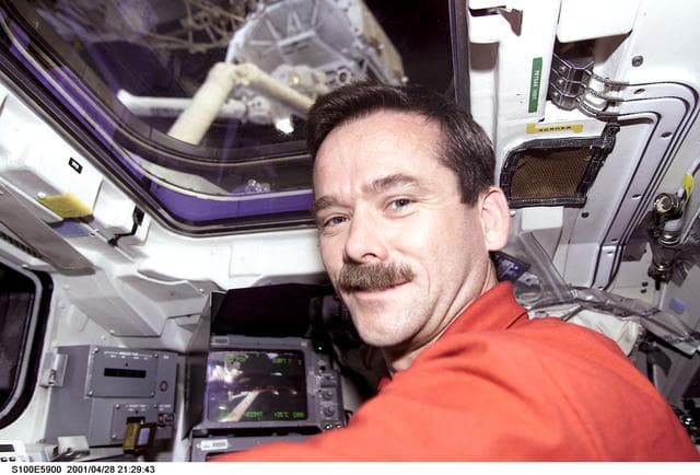 NASA image: MS Hadfield works at the RMS controls on the flight deck of Endeavour during RMS handshake