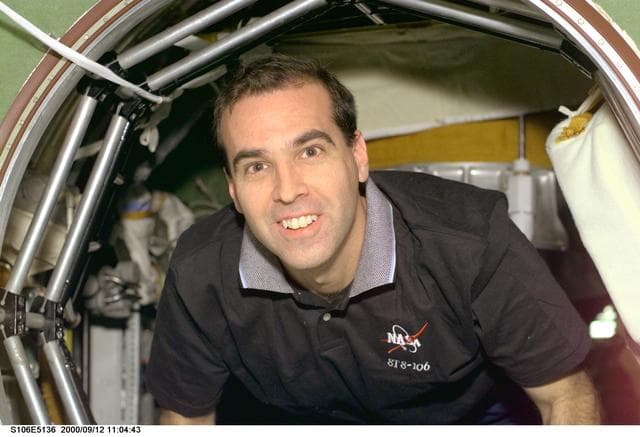 NASA image: MS Mastracchio moves through the hatch between Zarya and Zvezda