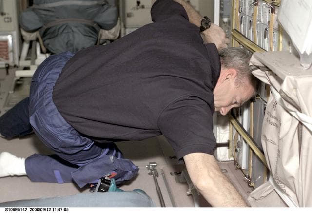 NASA image: Commander Wilcutt works on the Zvezda / Service Module during STS-106