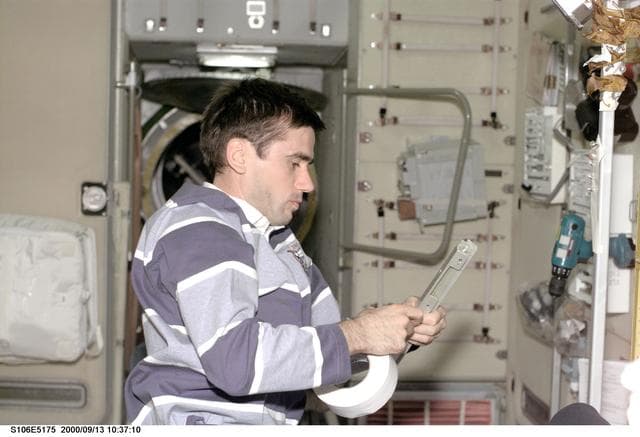 NASA image: MS Malenchenko tapes brackets in Zvezda during STS-106