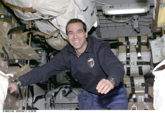 NASA image: MS Mastracchio works with stowage equipment in SpaceHab during STS-106