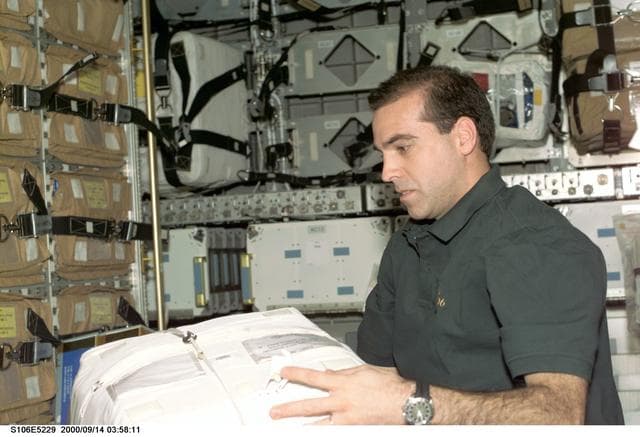NASA image: MS Mastracchio works with stowage bags in SpaceHab during STS-106