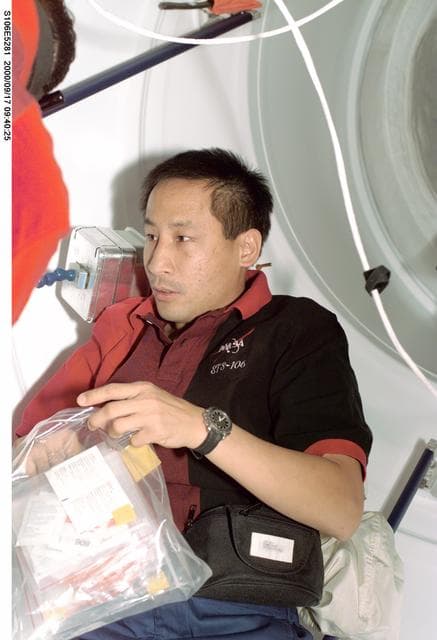 NASA image: MS Lu works in the transfer tunnel during STS-106